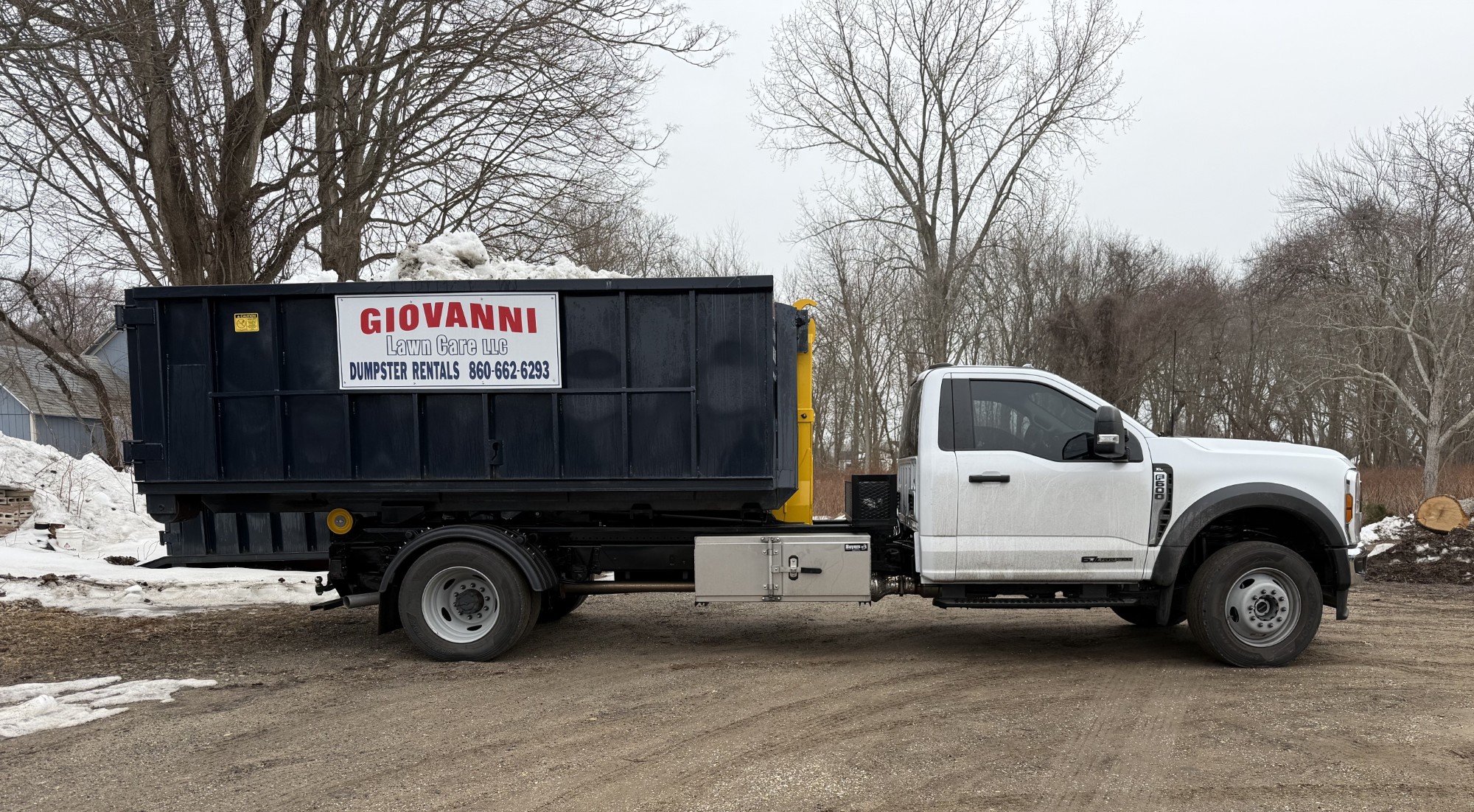 Giovanni Lawn Care roll-off dumpster rental truck