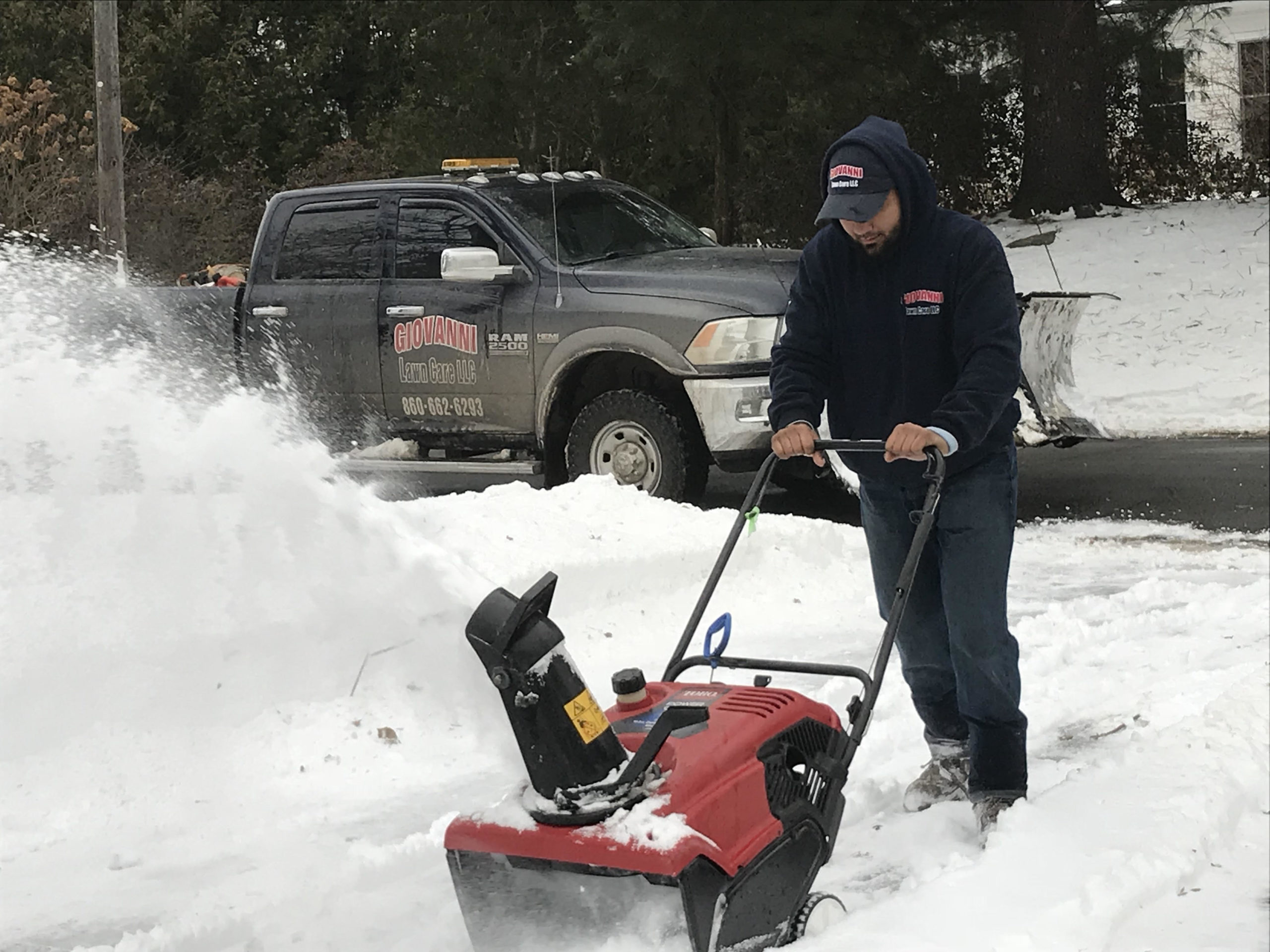 Giovanni Lawn Care crew clearing snow from a Connecticut property
